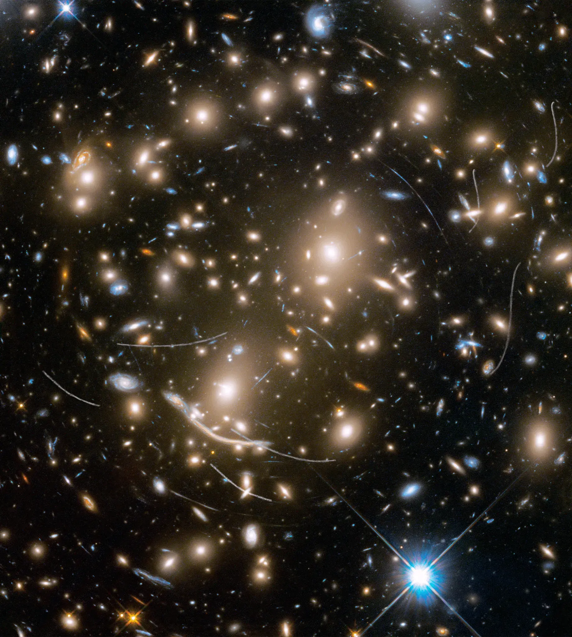 Galaxy cluster Abell 370, where gravity bends light from more distant galaxies into long curved arcs.